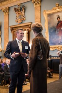Jason Wyatt from JCB receiving the Award from HRH The Princess Royal